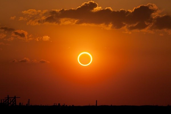 Annular Eclipse Photo of the sun in an orange sky                       