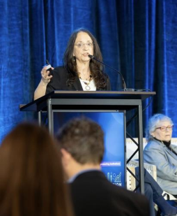 Carol O’Donnell speaking at a podium