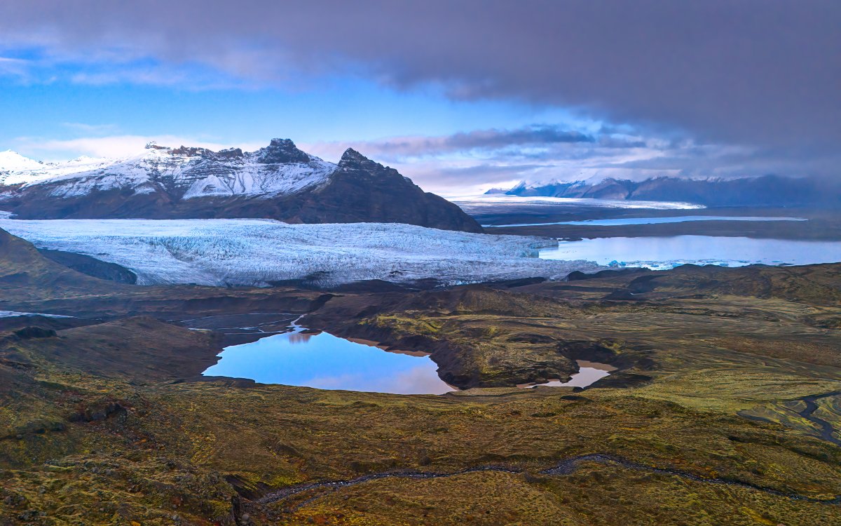 a breathtaking visa of an artic tundra with a small lake