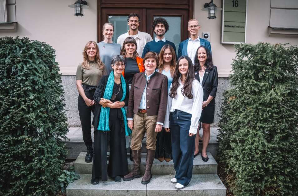 Carol O’Donnell posing for a picture on a door stoop with her Colleagues from the International Dialogue on  STEM Education. 