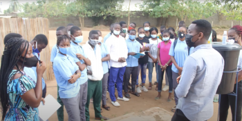 Students in Benin gather around a sanitation station