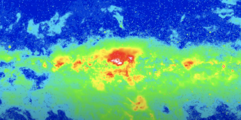 A view of the night sky in gamma rays so it shows bright green with a small bit of red yellow and blue.