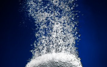 An antacid bubbling as it is disolved in water
