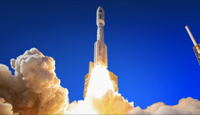 A blue sky with a white rocket launching