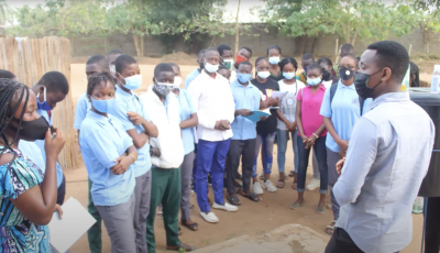 Students in Benin gather around a sanitation station