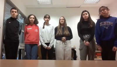 A group of 5 middle school girls and 1 middle school boy looking at the camera