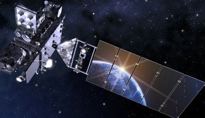 A satellite in space with the Earth reflecting in its solar panel