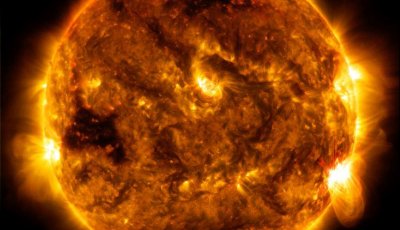 Yellow, orange and black image of the sun with solar flares