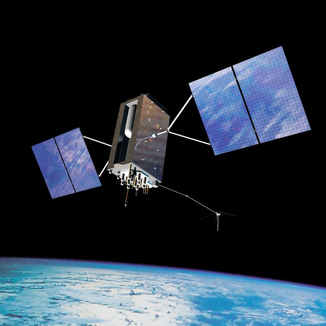 A satellite with grey body and blue solar panels orbiting Earth.